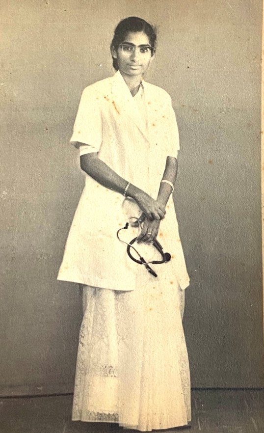 Grace as a newly qualified doctor, in a white coat, holding a stethoscope.