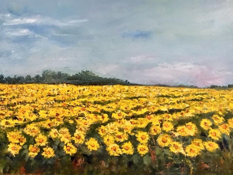 An oil painting by Grace McKee of a field of sunflowers under a grey sky.