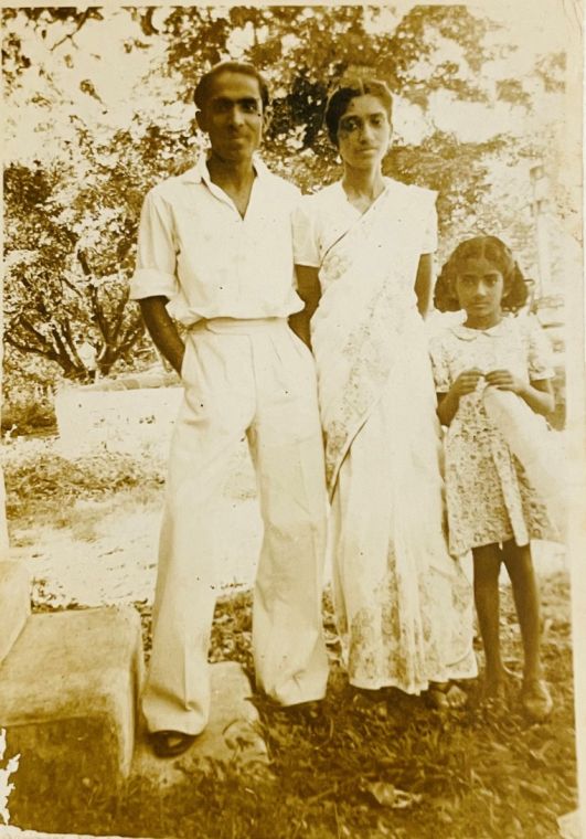 Grace as a girl with her mother and stepfather in a garden in India.