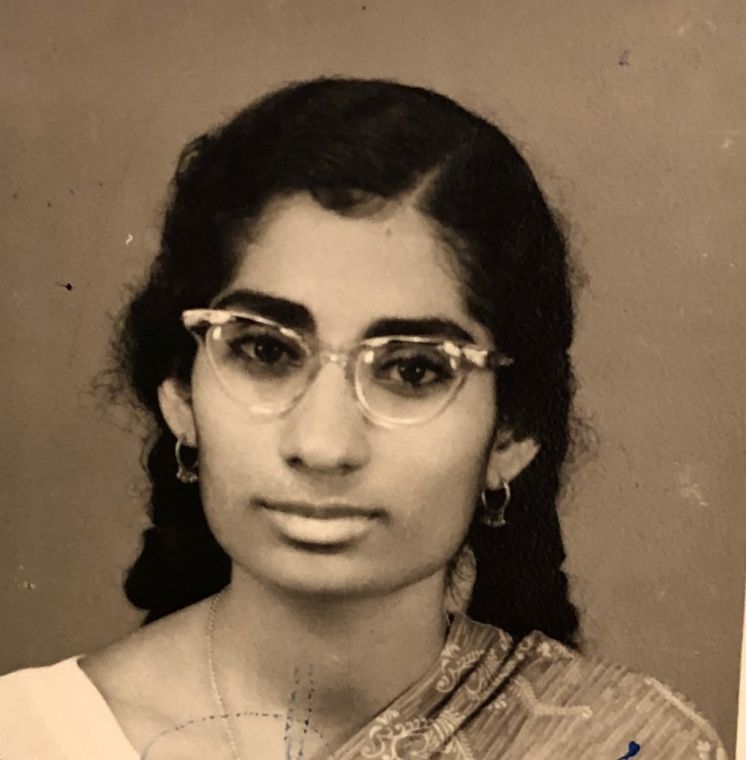 A portrait of Grace as a young woman in spectacles and a sari.
