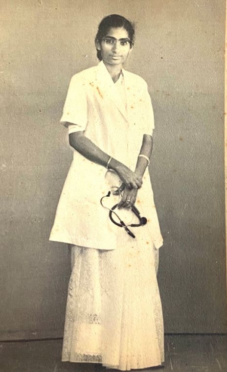 Grace as a newly qualified doctor in a white coat, holding a stethoscope.